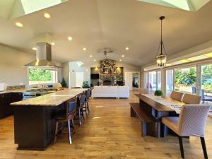 a large kitchen with a large island with a counter top at New Lighthouse Port Susan View House Camano in Bretland