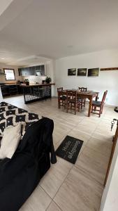 a living room with a table and a dining room at Casa Los Ñires Ushuaia in Ushuaia