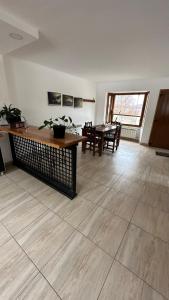 a living room with a table and a dining room at Casa Los Ñires Ushuaia in Ushuaia