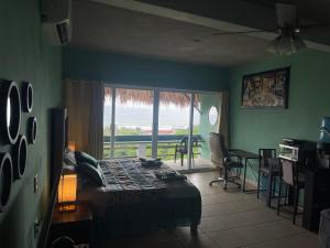 a bedroom with a bed and a view of the ocean at Brisa del Mar #6 in Brisas de Zicatela