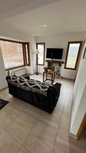 a bedroom with a large bed and a television at Casa Los Ñires Ushuaia in Ushuaia