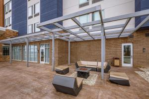 a patio with awning on a brick building at SpringHill Suites by Marriott Detroit Sterling Heights in Sterling Heights