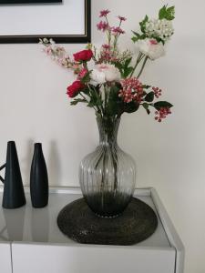 a vase filled with flowers sitting on a table at Beautiful Apartment 2 BR in Panama City