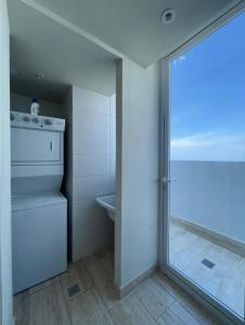 uma casa de banho com um lavatório, um WC e uma janela. em Beautiful Apartment 2 BR na Cidade do Panamá