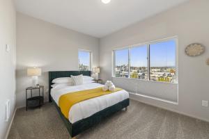 a bedroom with a large bed and a large window at BRAND NEW Fully Updated Condo 918 in Anacortes in Anacortes
