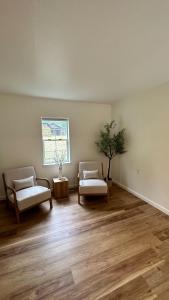 a living room with two chairs and a window at New Sauk River Retreat Concrete Wa in Concrete