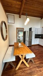 a kitchen with a wooden table and a refrigerator at New Sauk River Retreat Concrete Wa in Concrete