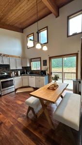 a kitchen with a wooden table in the middle at New Sauk River Retreat Concrete Wa in Concrete