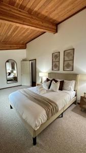 a bedroom with a large bed with a wooden ceiling at New Sauk River Retreat Concrete Wa in Concrete