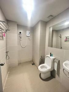 a bathroom with a shower and a toilet and a sink at SUMMER SUITES APARTMENT-The Summer Shopping Mall in Kota Samarahan +8 photos
