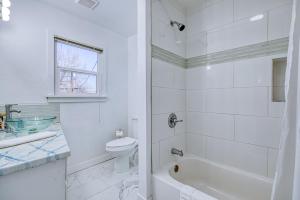 a white bathroom with a tub and a toilet at New Downtown Boise on Bsu Campus 3 Beds Sleeps 6 in Boise