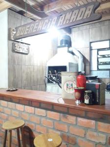 a kitchen with a brick counter top with a counter top at Cabana praia dos passarinhos in Viamão
