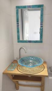 a bathroom sink with a mirror on top of it at Quédate Aquí in Las Galeras