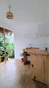 a kitchen with a sink and a wooden counter top at Quédate Aquí in Las Galeras