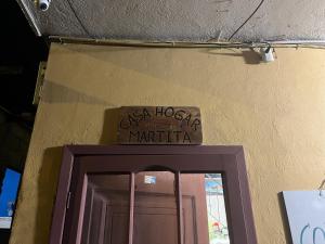 a sign above a door in a building at Casa Hogar Martita in Puerto Baquerizo Moreno