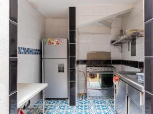 a kitchen with a refrigerator and a stove at Villa Candelaria Hostel in Bogotá