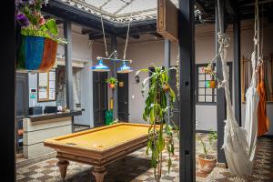 a ping pong table in a room with potted plants at Villa Candelaria Hostel in Bogotá