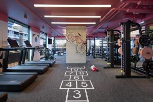 a gym with a bunch of bikes and machines at Moxy Sydney Airport in Sydney