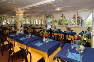 a dining room with blue tables and chairs at Hotel Villa Fiorentina in Ischia