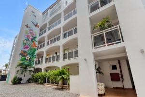 a building with a mural on the side of it at Maho Beach House - Spacious 1 Bedroom Suite in Maho Reef