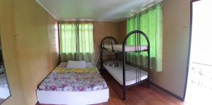 a small room with a bunk bed and a bunk bed gmaxwell gmaxwell gmaxwell at Amara Transient House in Baguio