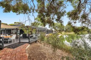 an external view of a house with a river at Mid Century 4 Bedroom Getaway in Barossa Vineyard in Nuriootpa