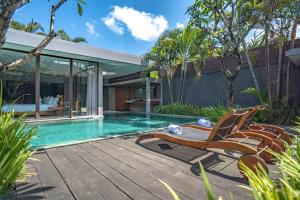 a house with a swimming pool and a deck at Ziva a Boutique Villa in Seminyak