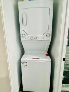 una lavatrice e un'asciugatrice bianche in una stanza di VJ Home a Toronto