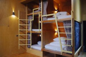 a room with three bunk beds in it at Funzpace in Hengchun South Gate