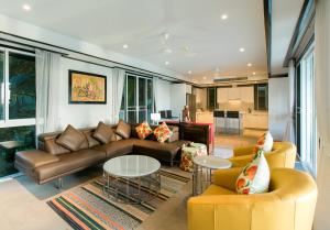 a living room with a couch and a table and chairs at Katamanda Villa Mila A1 in Kata Beach