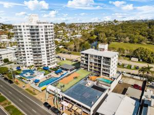 an aerial view of a city with a building and a pool at Avalon on Alex Beach 2 Bedroom Apartment in Alexandra Headland