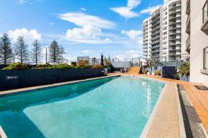 a swimming pool on the side of a building at Avalon on Alex Beach 2 Bedroom Apartment in Alexandra Headland