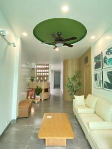 a living room with a couch and a green ceiling at Happy Hotel Bình Tân in Ho Chi Minh City