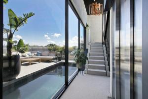 a house with a swimming pool and glass windows at Entertainers penthouse with 5 bedrooms pool & spa in Auckland
