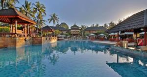 a large swimming pool in front of a resort at Cozy Bali Apartment in Seminyak