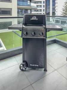 a grill sitting on top of a balcony at Mount Eleven Fabulous Sea Views in Mount Maunganui
