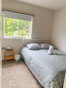 a bedroom with a bed and a window at Barrie Ocean Kingdom in Barrie