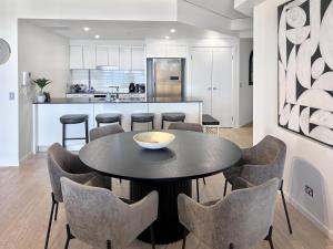 a kitchen and dining room with a table and chairs at Incredible ocean views 3 Bed 18th floor in Gold Coast