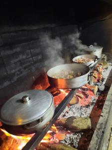 a group of pots and pans on a grill at Ferme auberge le Ti'planteur in Saint-Philippe