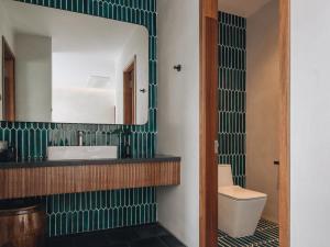 a bathroom with a sink and a mirror at Le Mint Hotel Quy Nhơn in Quy Nhon