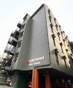 a building with a sign that reads stay hotelasc at mySTAY Hotel BGC South in Manila