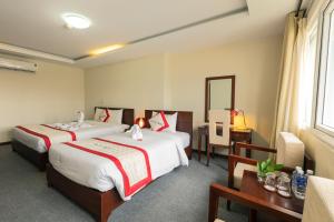 Voodi või voodid majutusasutuse Tien Sa Danang Hotel toas