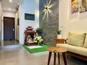 a living room with a couch and a fireplace at Han Apartment in Da Nang