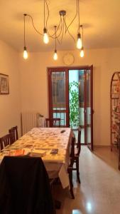 a dining room with a large wooden table with chairs at Affitta camere da Marcello in Santo Spirito