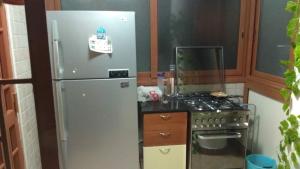 a kitchen with a refrigerator and a stove at Affitta camere da Marcello in Santo Spirito