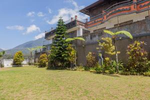 a building with a tree in front of it at Lavender - Taman Tanda in Bedugul
