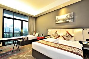 a hotel room with two beds and a desk at Maison 101 Dang Wangi in Kuala Lumpur