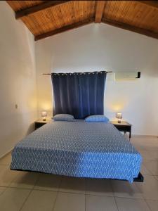 a bedroom with a blue bed with two night stands at Casa angelina in Sosúa