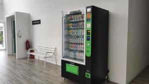 a vending machine with drinks in a room at Pink Studio Serene Heights Condo One bedroom 2 beds & Sofa Bed in Miri
