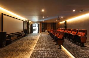 a conference room with chairs and a large screen at Family-Friendly 3-Bedroom Condo at IOI Resort City in Kampong Abu Bakar +57 photos